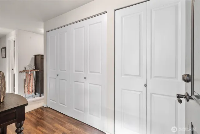 a view of a livingroom with a furniture a ceiling fan and wooden floor