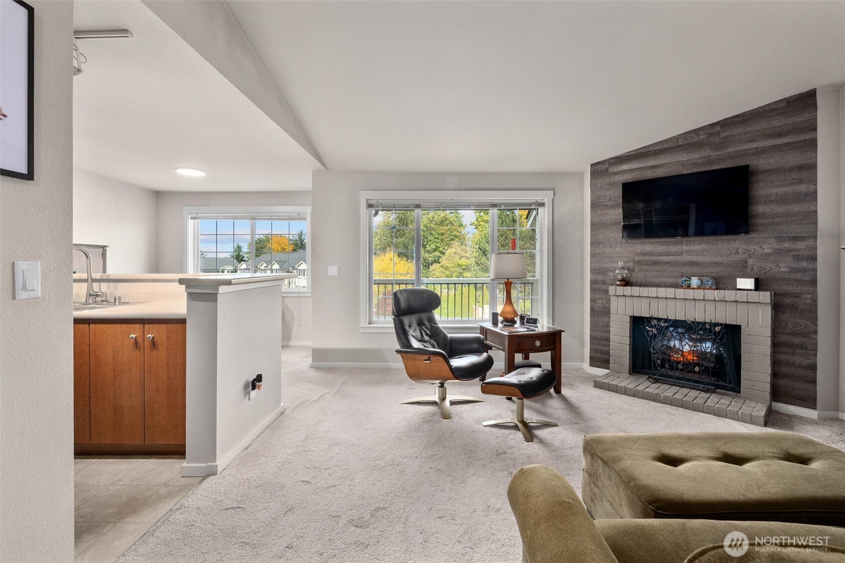 12404 East Gibson Road, Unit H301 Everett, WA 98204 - Photo 6 of 36 a living room with furniture and a fireplace