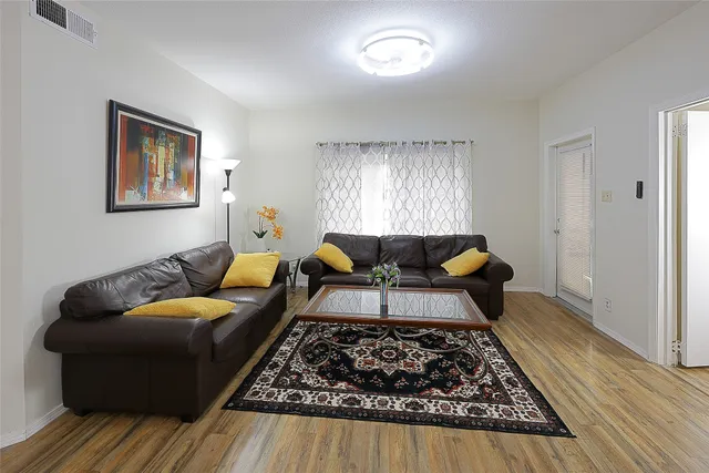a living room with furniture and a rug