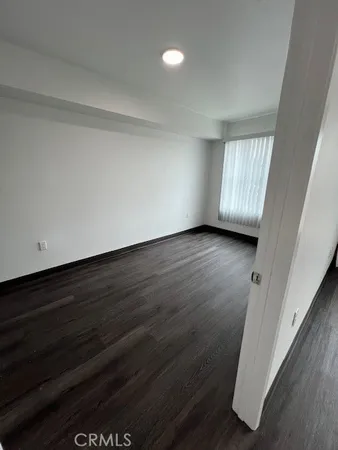 a view of a kitchen with wooden floor and a sink