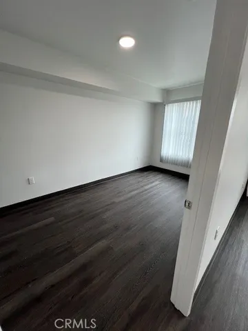 a view of a kitchen with wooden floor and a sink