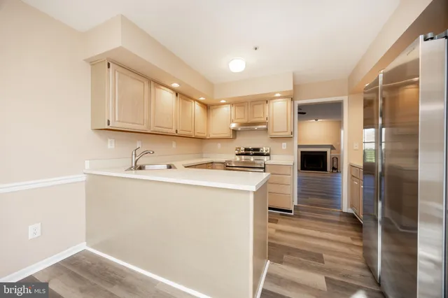 a kitchen with kitchen island a sink stainless steel appliances and cabinets