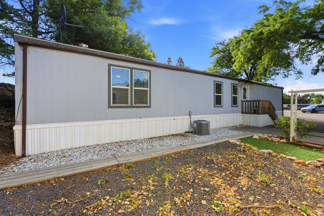 2875 North Hill Field Road, Unit 62 Layton, UT 84041 - Photo 4 of 34 Light gray siding with white skirting and dark trim