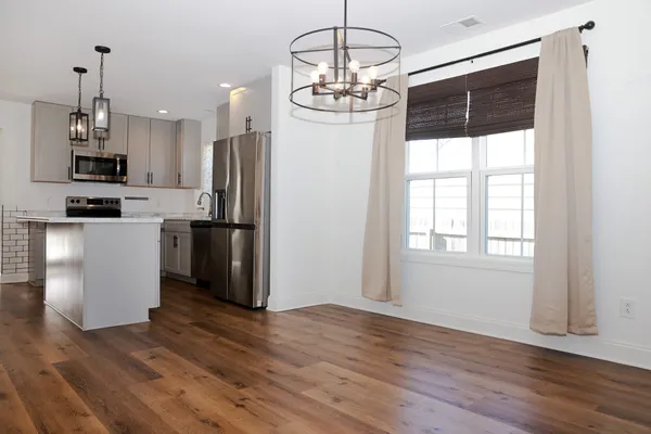 a kitchen with stainless steel appliances granite countertop a refrigerator and a stove top oven