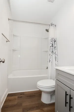 a bathroom with a toilet and a shower