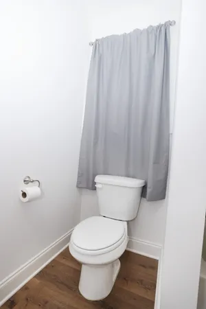a white toilet sitting next to a small sink