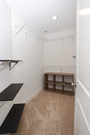 a bedroom with a bed and a ceiling fan