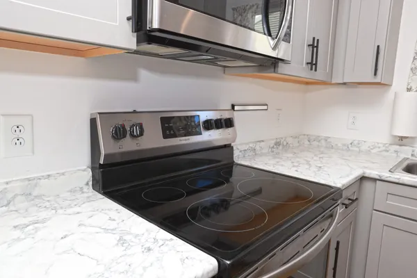 a stove top oven sitting inside of a kitchen