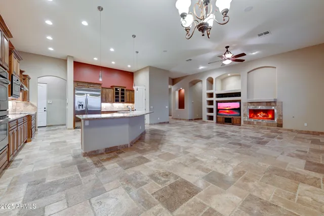 a large kitchen with stainless steel appliances granite countertop a stove and a sink