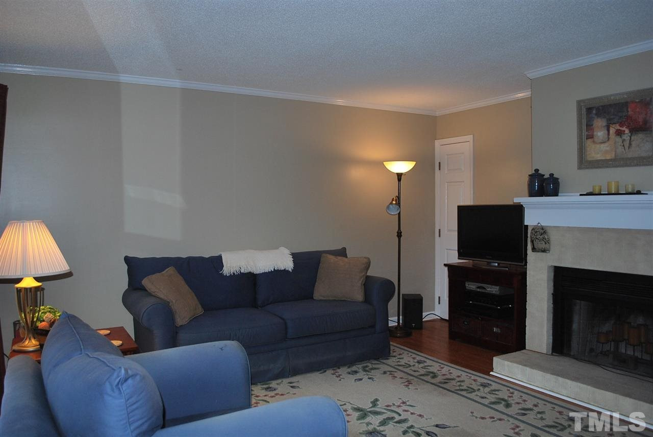 725 Charleston Road, Unit 725 Raleigh, NC 27606 - Photo 4 of 17 Fireplace, closet to the left, warm and cozy living space. Living Room