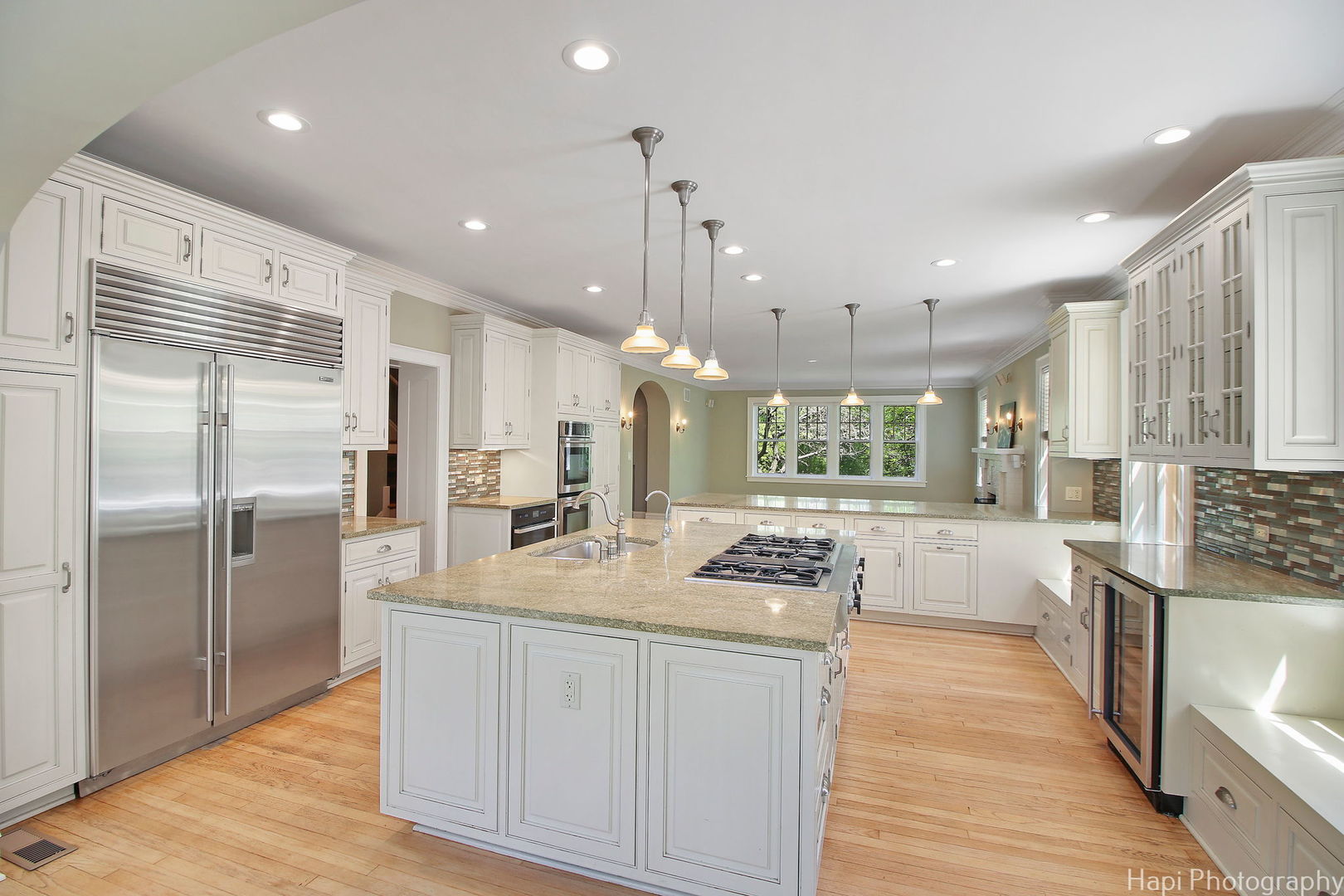 1403 Glenview Road Glenview, IL 60025 - Photo 11 of 62 a kitchen with stainless steel appliances kitchen island granite countertop a refrigerator a oven a sink and white cabinets with wooden floor