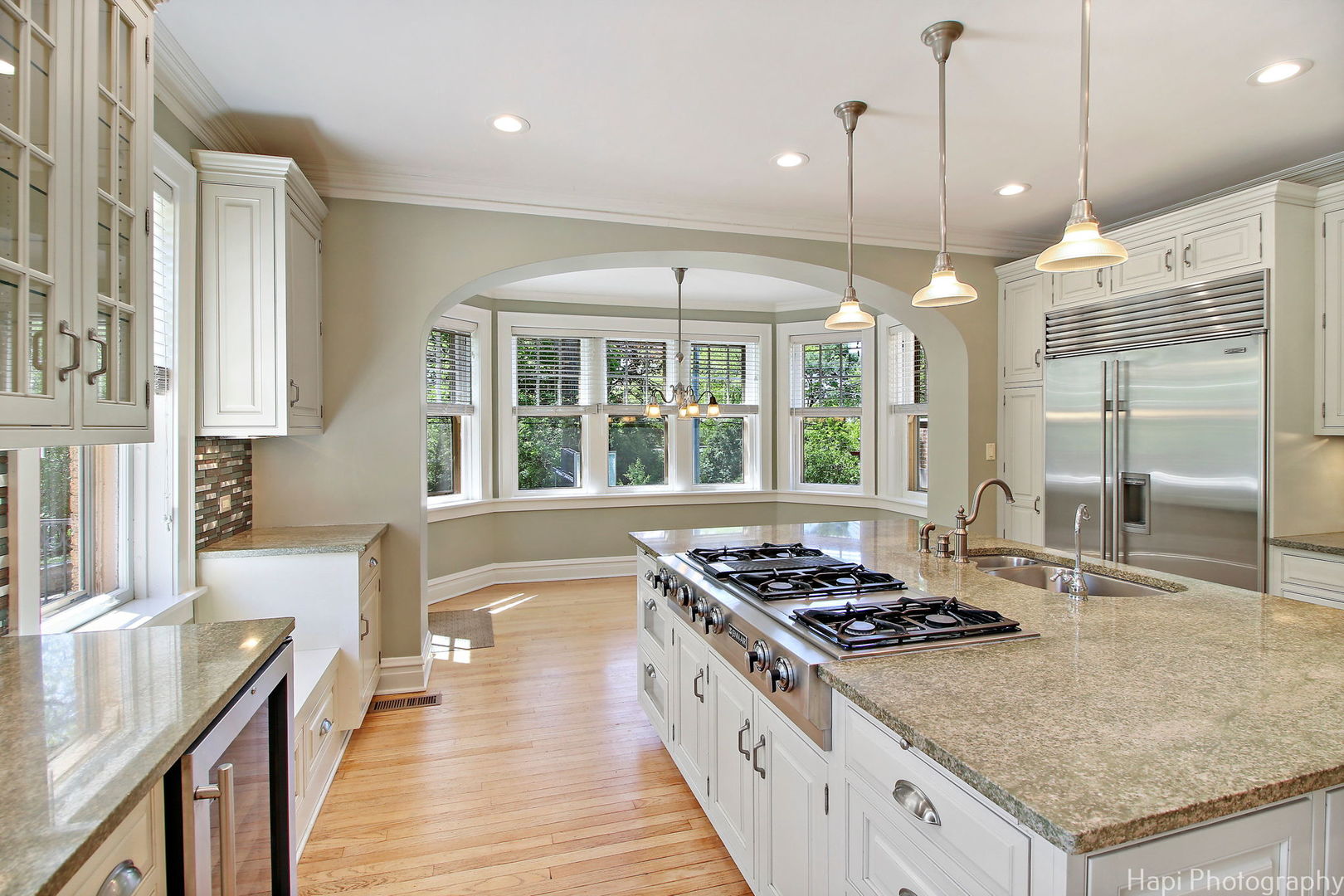 1403 Glenview Road Glenview, IL 60025 - Photo 12 of 62 a kitchen with stainless steel appliances granite countertop a stove a sink dishwasher and a refrigerator with wooden floor