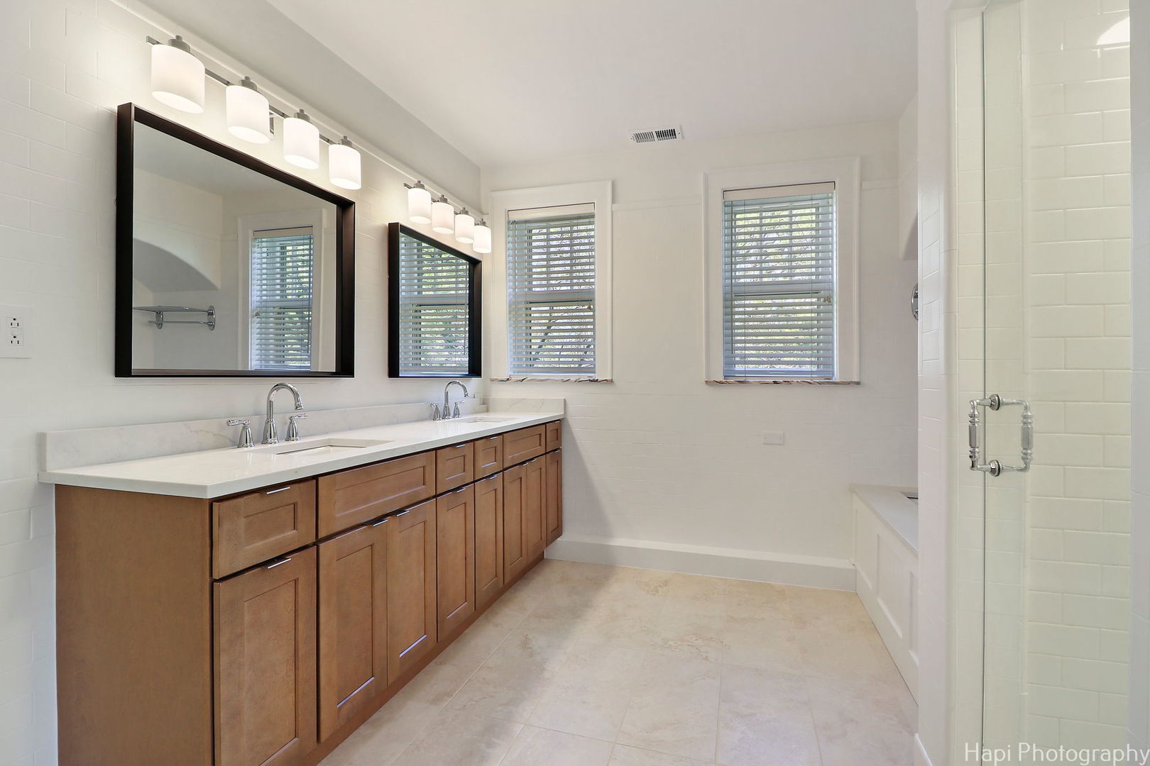 1403 Glenview Road Glenview, IL 60025 - Photo 30 of 62 a bathroom with a double vanity sink and mirror with window