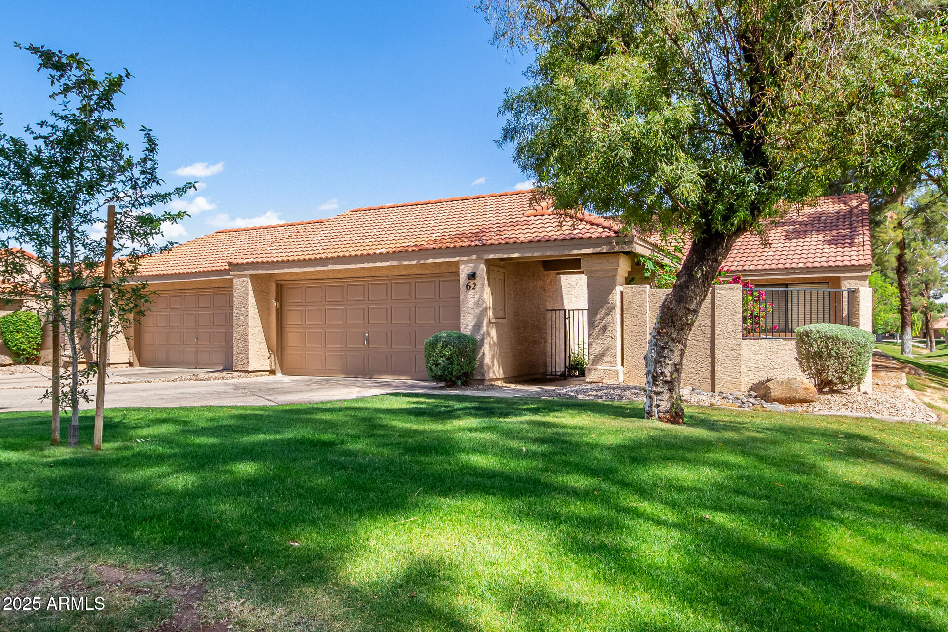 945 North Pasadena, Unit 62 Mesa, AZ 85201 - Photo 14 of 30 a front view of a house with a yard and garage