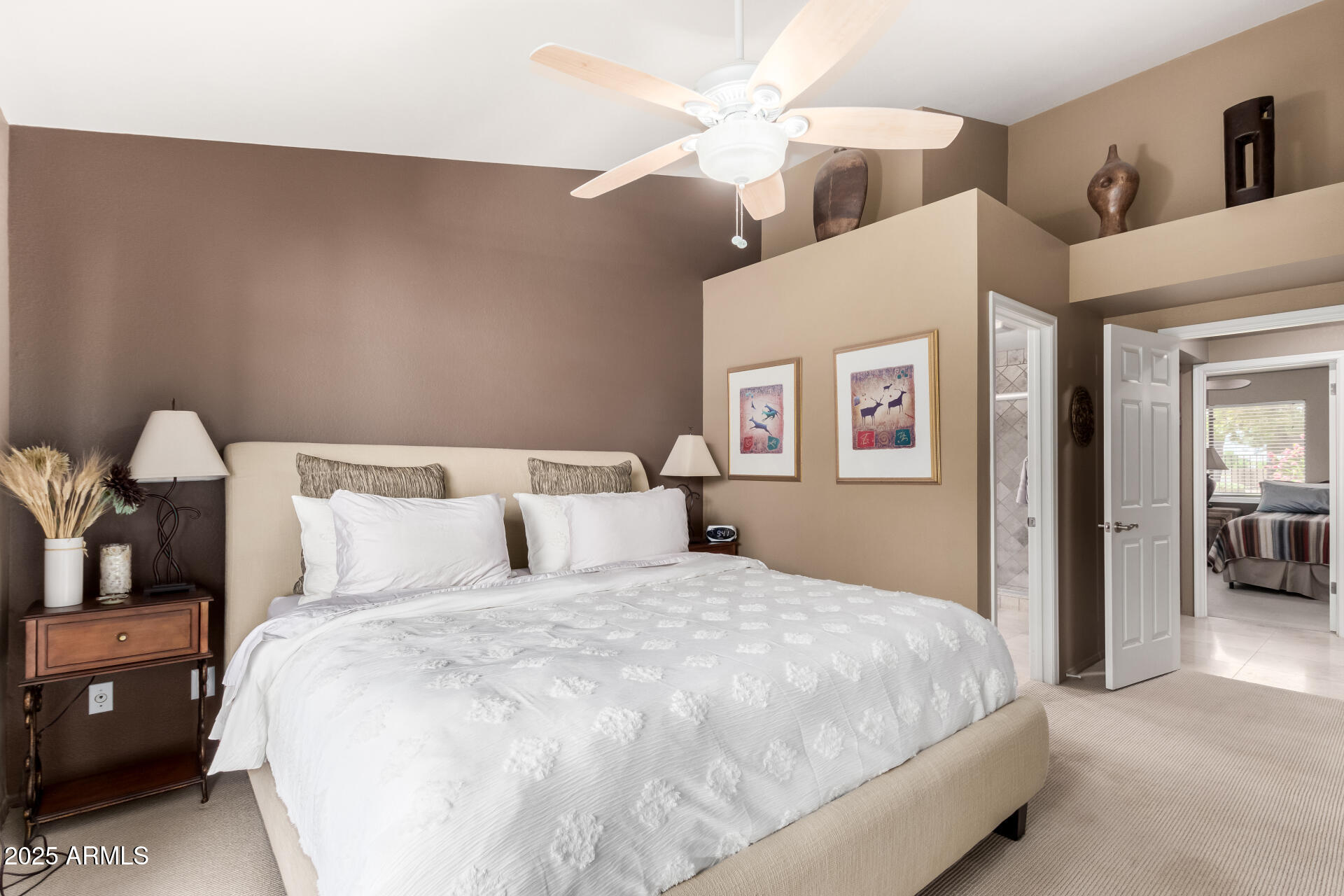 945 North Pasadena, Unit 62 Mesa, AZ 85201 - Photo 19 of 30 a bedroom with a large bed and a chandelier