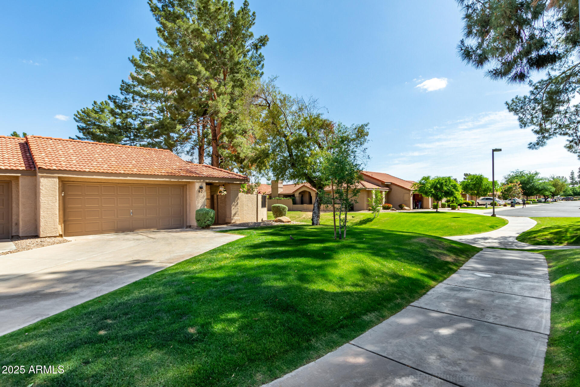 945 North Pasadena, Unit 62 Mesa, AZ 85201 - Photo 2 of 30 a view of a house with a yard and a street