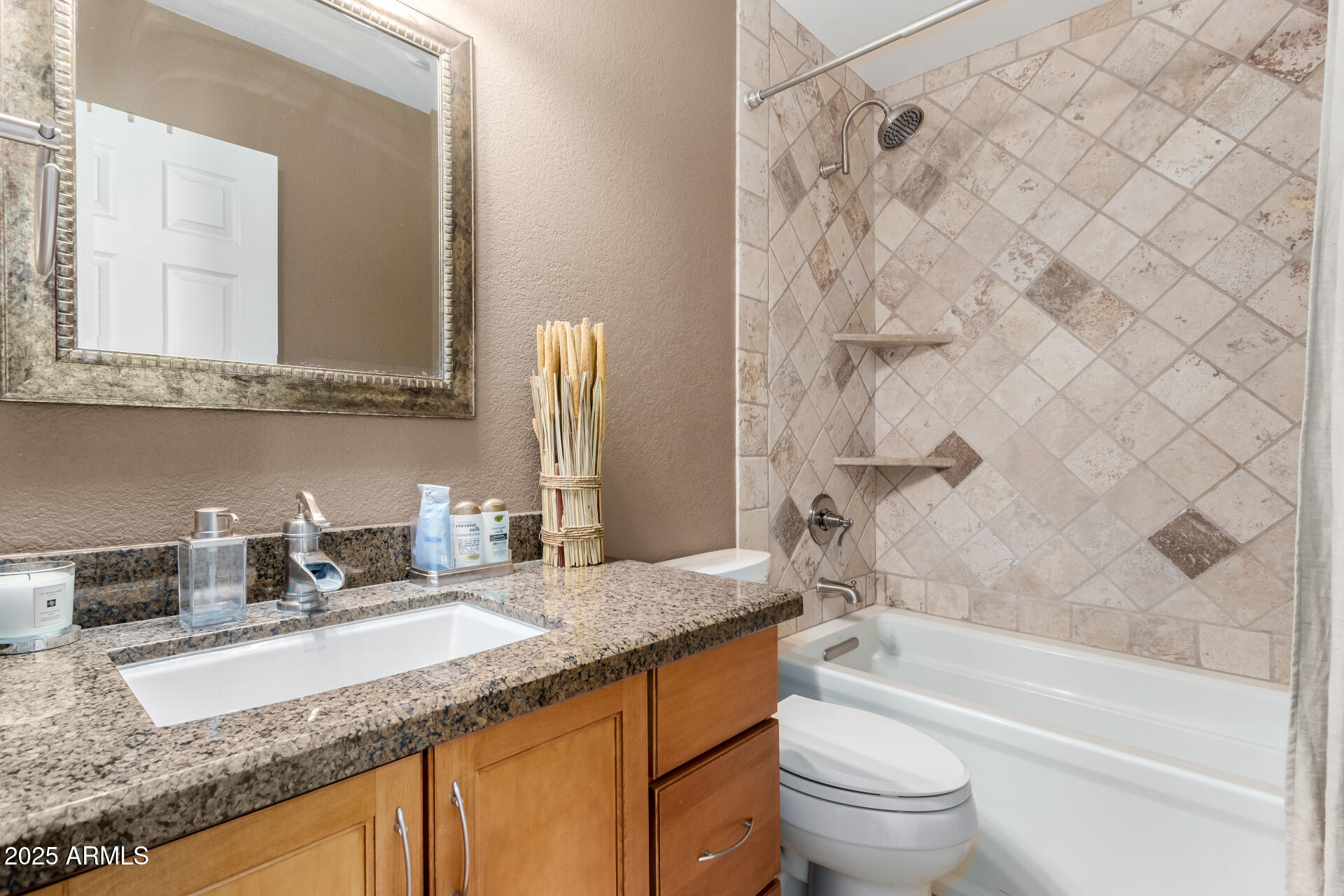 945 North Pasadena, Unit 62 Mesa, AZ 85201 - Photo 25 of 30 a bathroom with a granite countertop bathtub sink vanity mirror and toilet
