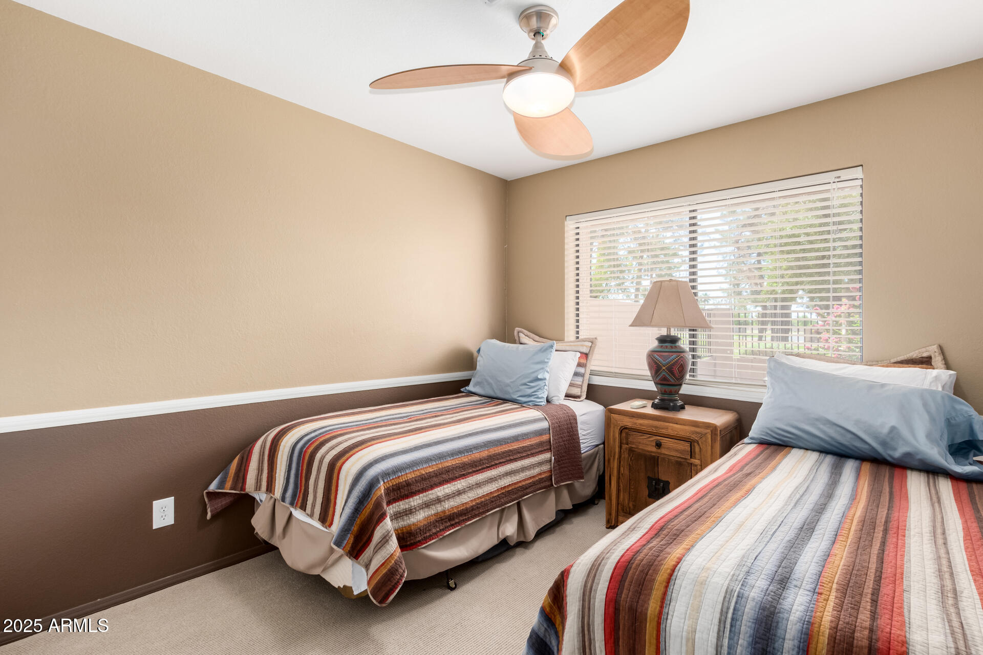 945 North Pasadena, Unit 62 Mesa, AZ 85201 - Photo 26 of 30 a bedroom with two beds and a chandelier