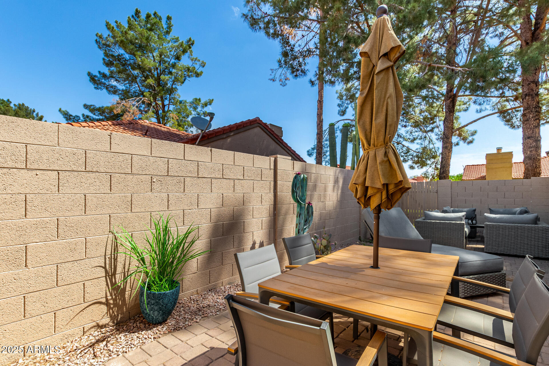 945 North Pasadena, Unit 62 Mesa, AZ 85201 - Photo 28 of 30 a table and chairs sitting in front of a house
