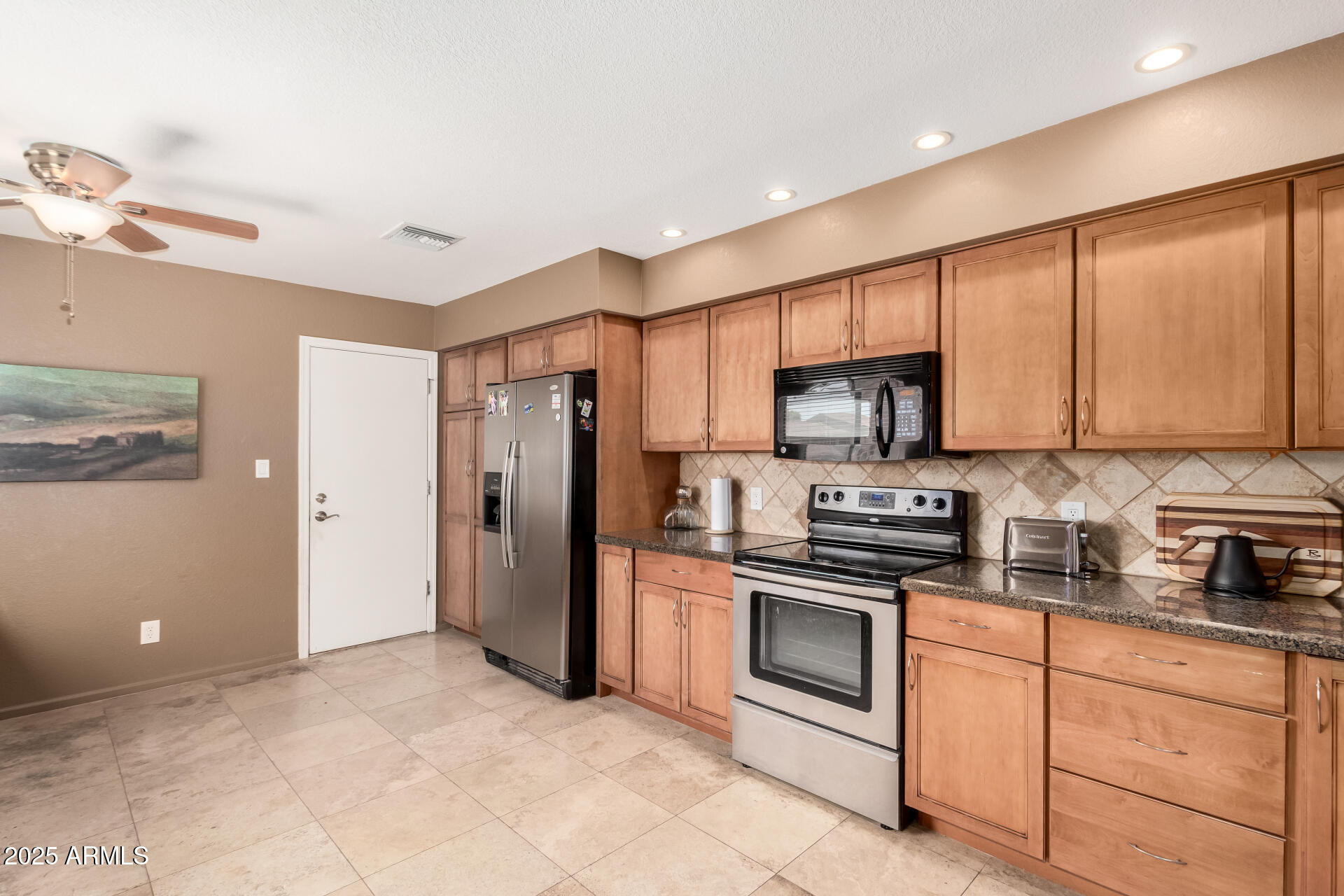 945 North Pasadena, Unit 62 Mesa, AZ 85201 - Photo 9 of 30 a kitchen with stainless steel appliances granite countertop a refrigerator oven a sink dishwasher and white cabinets with wooden floor