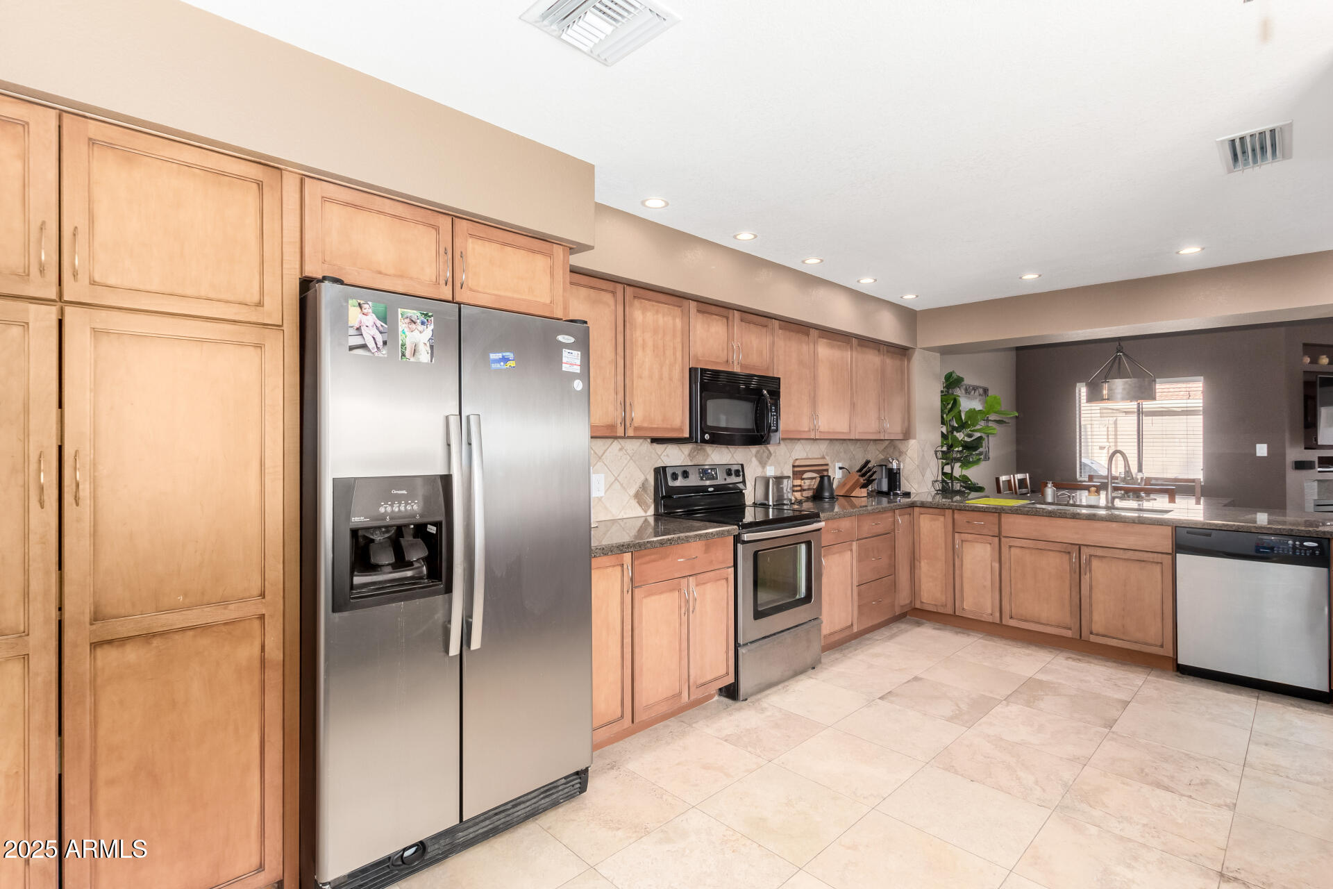 945 North Pasadena, Unit 62 Mesa, AZ 85201 - Photo 10 of 30 a large kitchen with cabinets and stainless steel appliances
