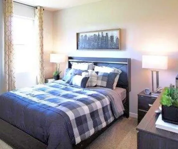 a kitchen with stainless steel appliances granite countertop a stove top oven a refrigerator a sink dishwasher with wooden cabinets and floor