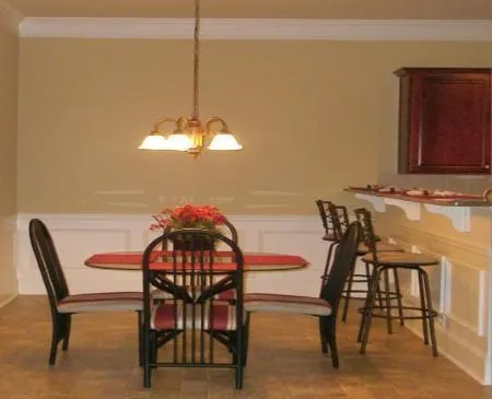 a living room with furniture a flat screen tv and a wall clock