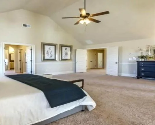 a bedroom with a bed and a chandelier