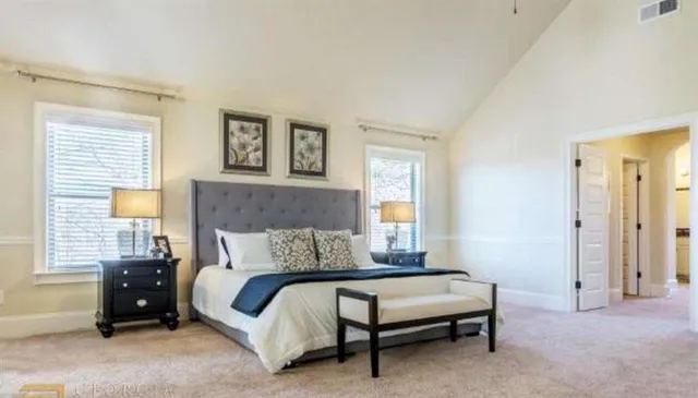 a bedroom with a bed and a chandelier