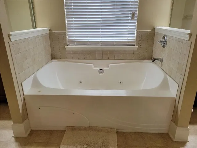 a bedroom with a bed and painting on the wall