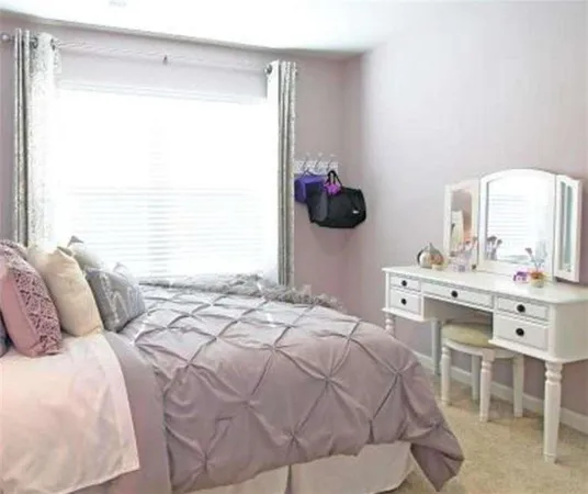 a bedroom with bed and a potted plant