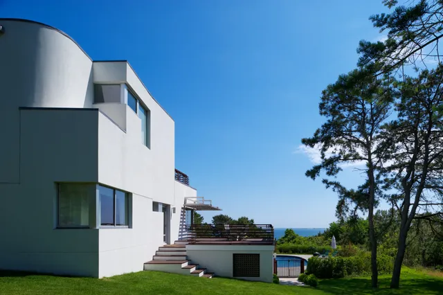a yellow house with trees in front of it