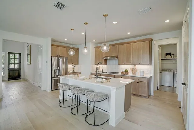a kitchen with counter space appliances and wooden floor