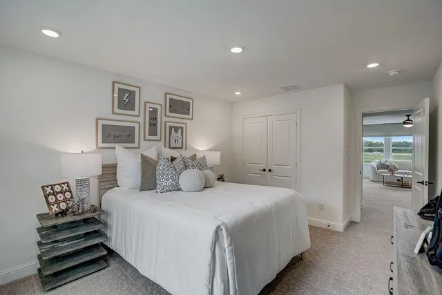 a bedroom with a bed and a painting on the wall