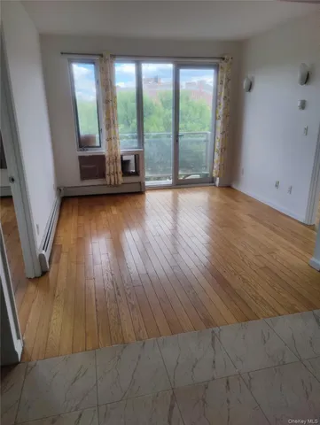a view of a room with wooden floor and walls