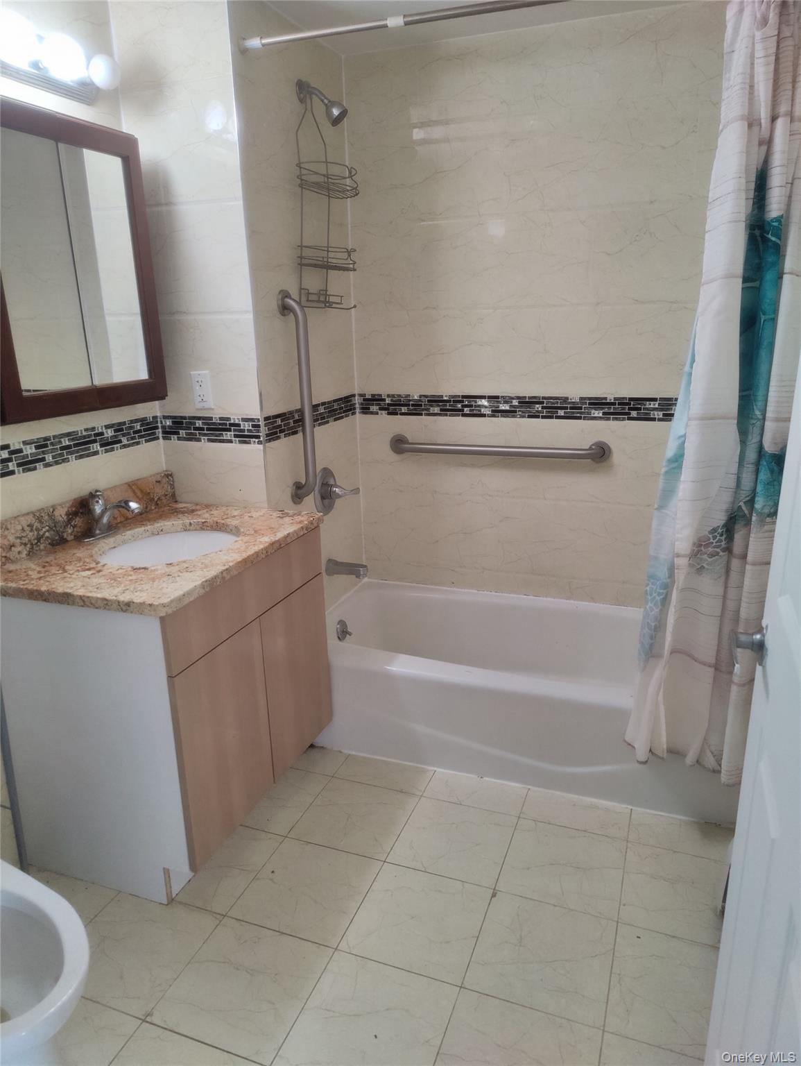 136-21 Latimer Place, Unit 3K Queens, NY 11354 - Photo 6 of 7 a bathroom with a sink and a mirror