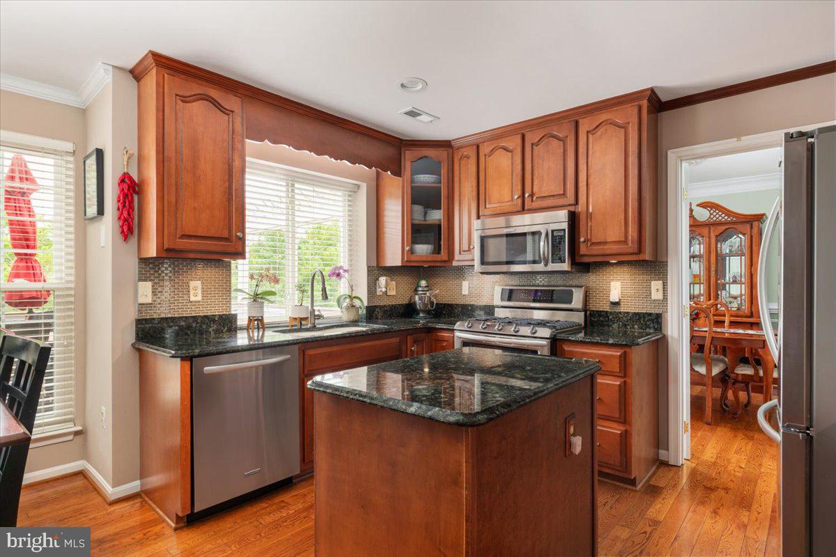 8236 Sunset Drive Manassas, VA 20110 - Photo 15 of 53 a kitchen with stainless steel appliances granite countertop a stove refrigerator sink and cabinets