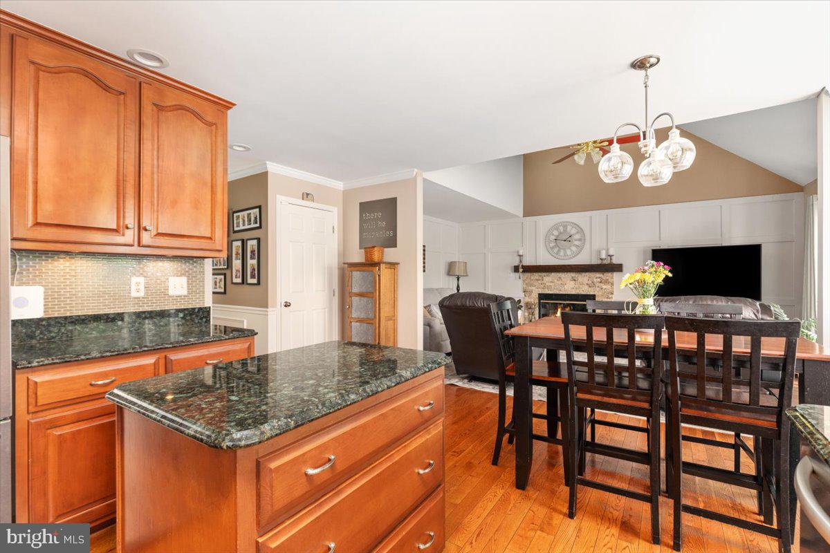 8236 Sunset Drive Manassas, VA 20110 - Photo 17 of 53 a kitchen with a table chairs refrigerator and cabinets