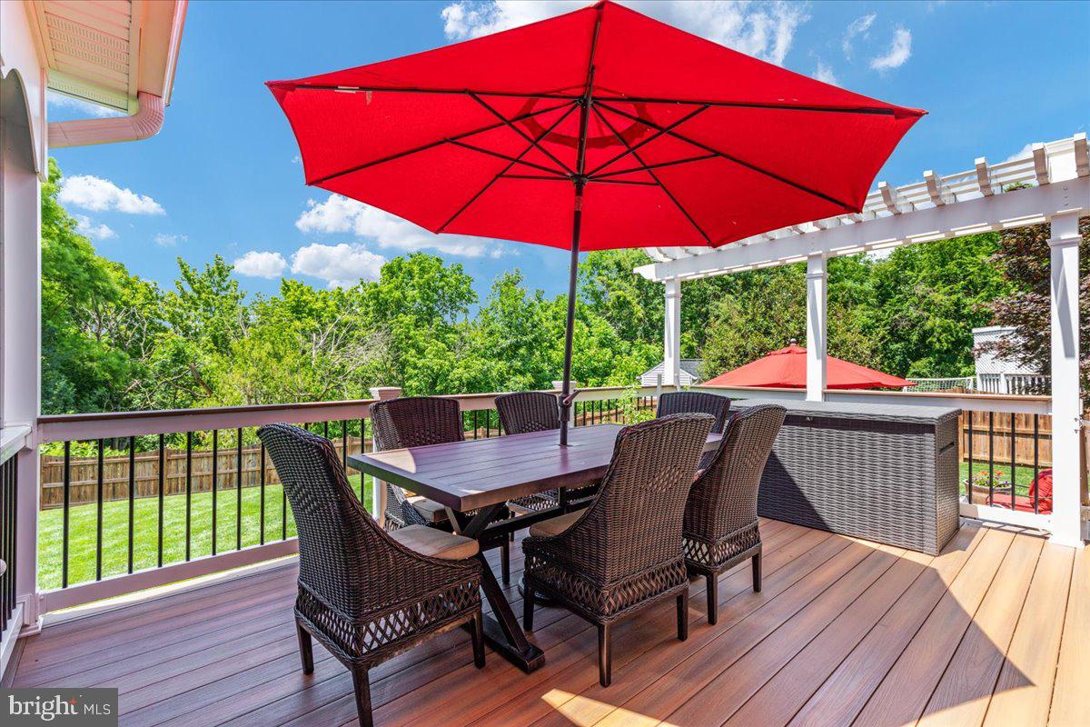 8236 Sunset Drive Manassas, VA 20110 - Photo 24 of 53 a patio with wooden floor a yard a table and chairs