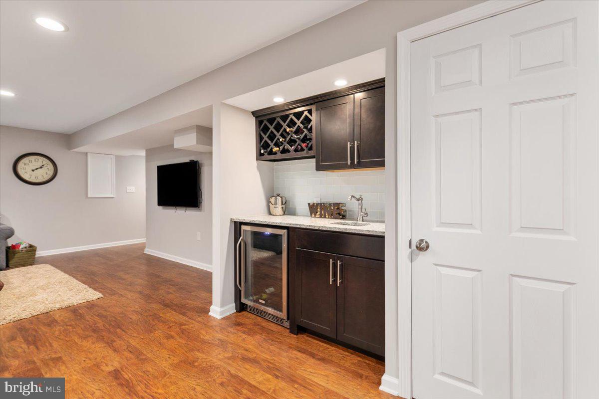 8236 Sunset Drive Manassas, VA 20110 - Photo 28 of 53 a view of kitchen with stainless steel appliances wooden floor and living room