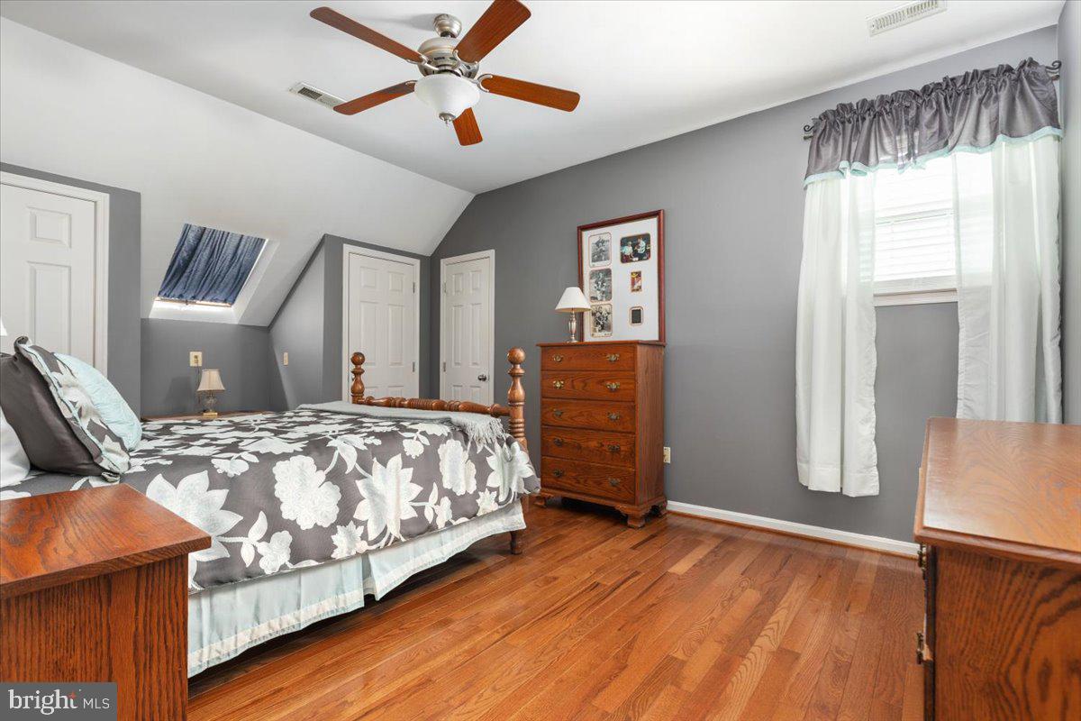 8236 Sunset Drive Manassas, VA 20110 - Photo 32 of 53 a bedroom with bed and wooden floor