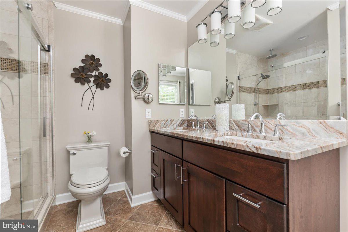 8236 Sunset Drive Manassas, VA 20110 - Photo 39 of 53 a bathroom with a granite countertop sink a toilet and a mirror