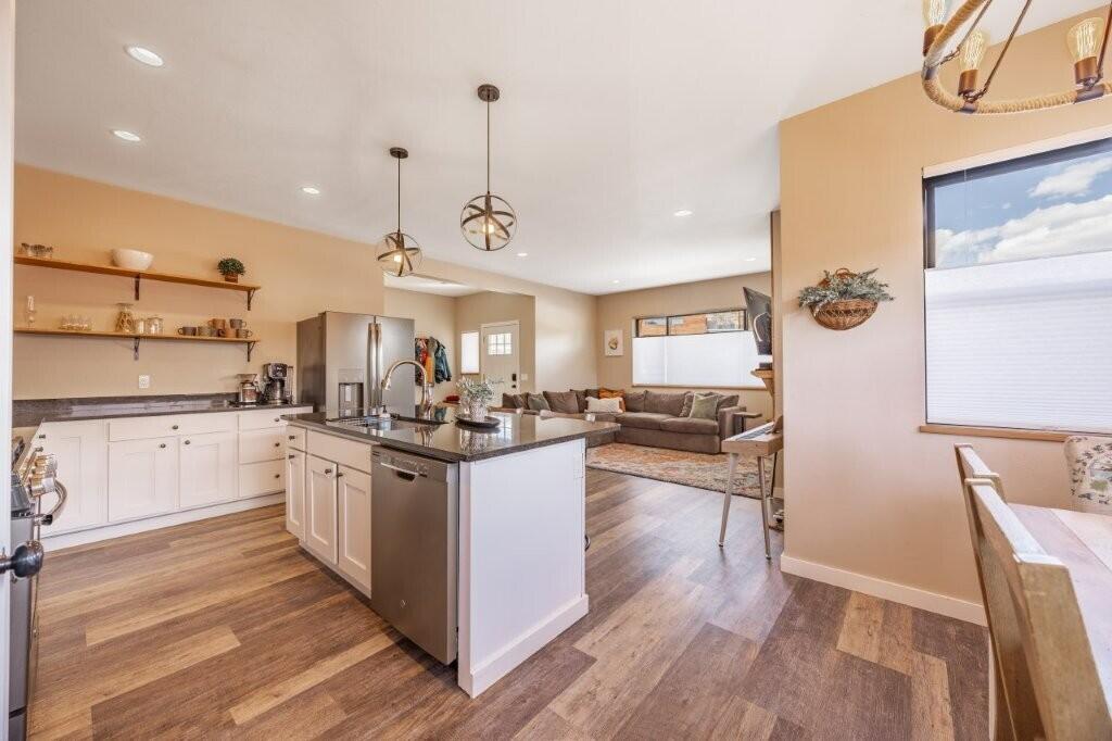 790 North Laura Street Ridgway, CO 81432 - Photo 11 of 42 a kitchen with stainless steel appliances granite countertop a sink a stove and refrigerator