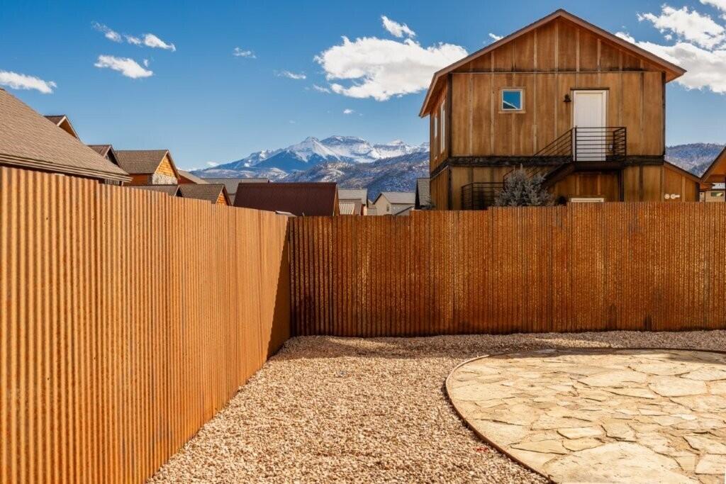 790 North Laura Street Ridgway, CO 81432 - Photo 14 of 42 a view of a house with a wooden fence