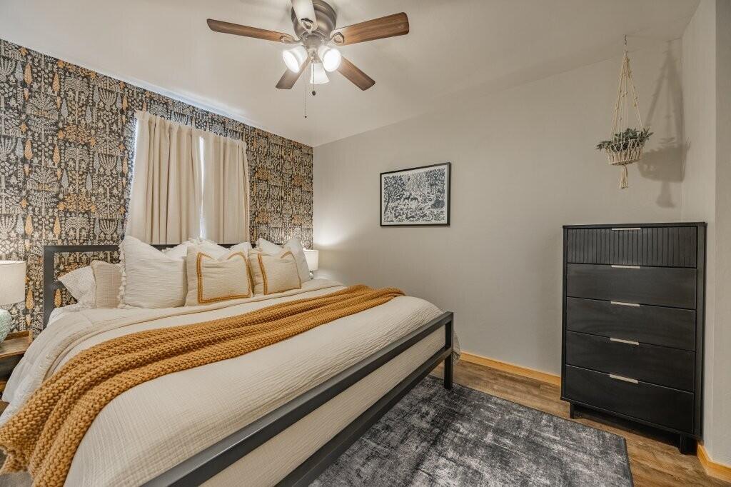 790 North Laura Street Ridgway, CO 81432 - Photo 28 of 42 a bedroom with a bed and a chandelier