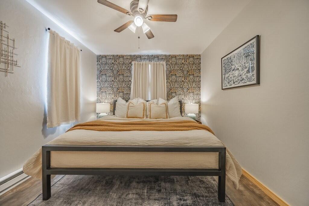 790 North Laura Street Ridgway, CO 81432 - Photo 35 of 42 a bedroom with a bed and a chandelier