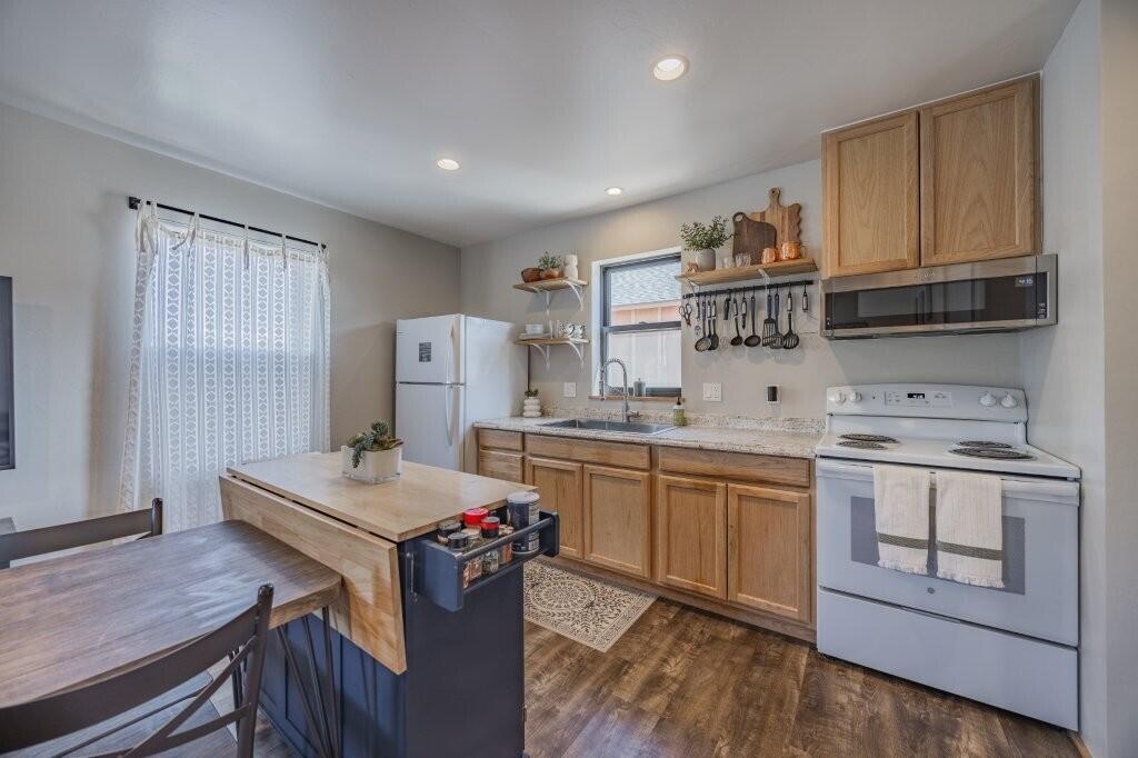 790 North Laura Street Ridgway, CO 81432 - Photo 41 of 42 a kitchen with a sink stove and cabinets