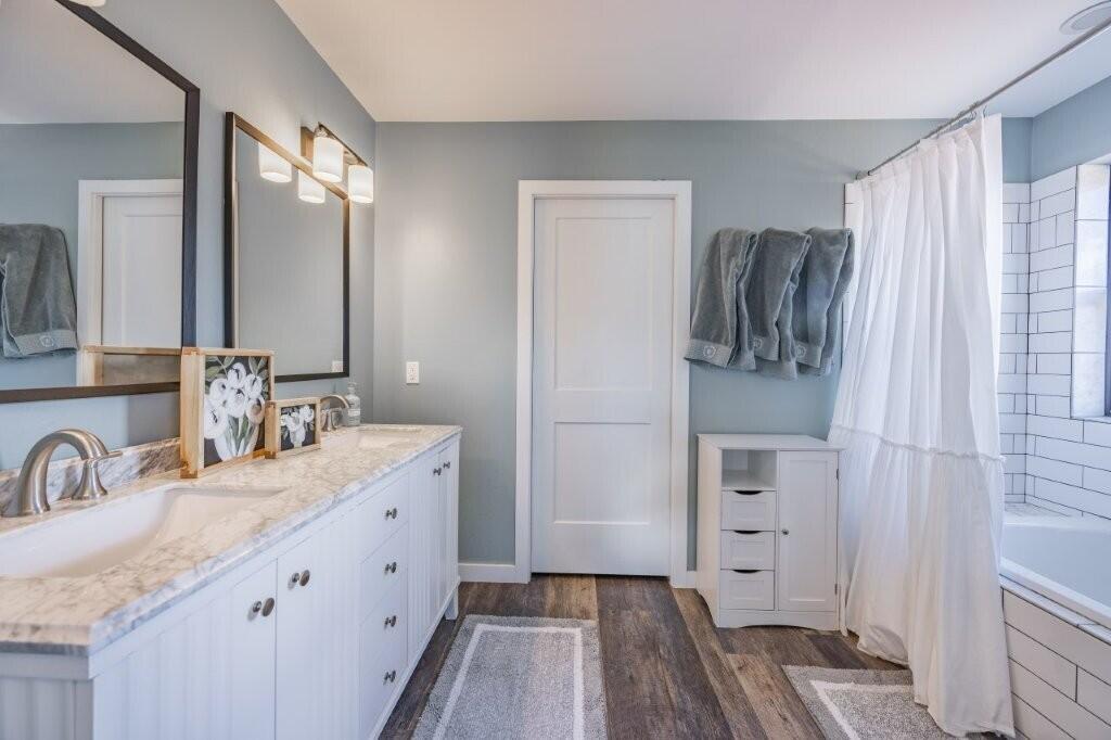 790 North Laura Street Ridgway, CO 81432 - Photo 7 of 42 a bathroom with a double vanity sink a mirror and a shower