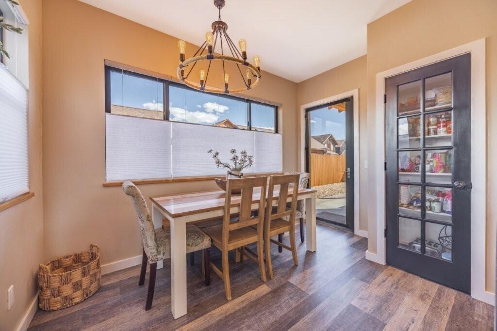 790 North Laura Street Ridgway, CO 81432 - Photo 8 of 42 a dining room with furniture wooden floor and a rug