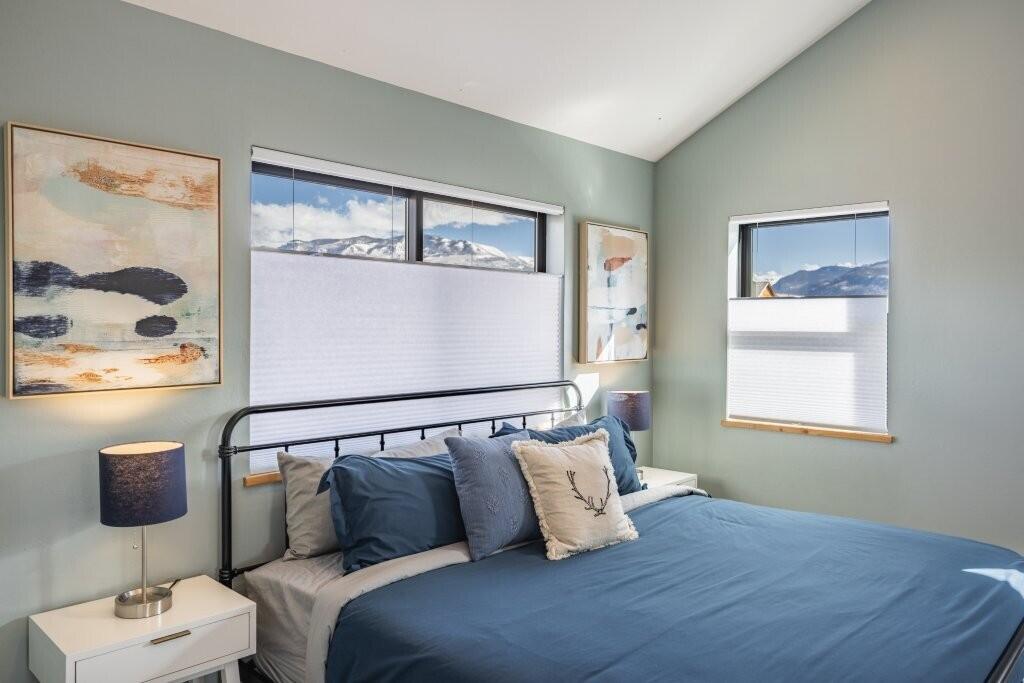 790 North Laura Street Ridgway, CO 81432 - Photo 10 of 42 a bedroom with a bed and glass window